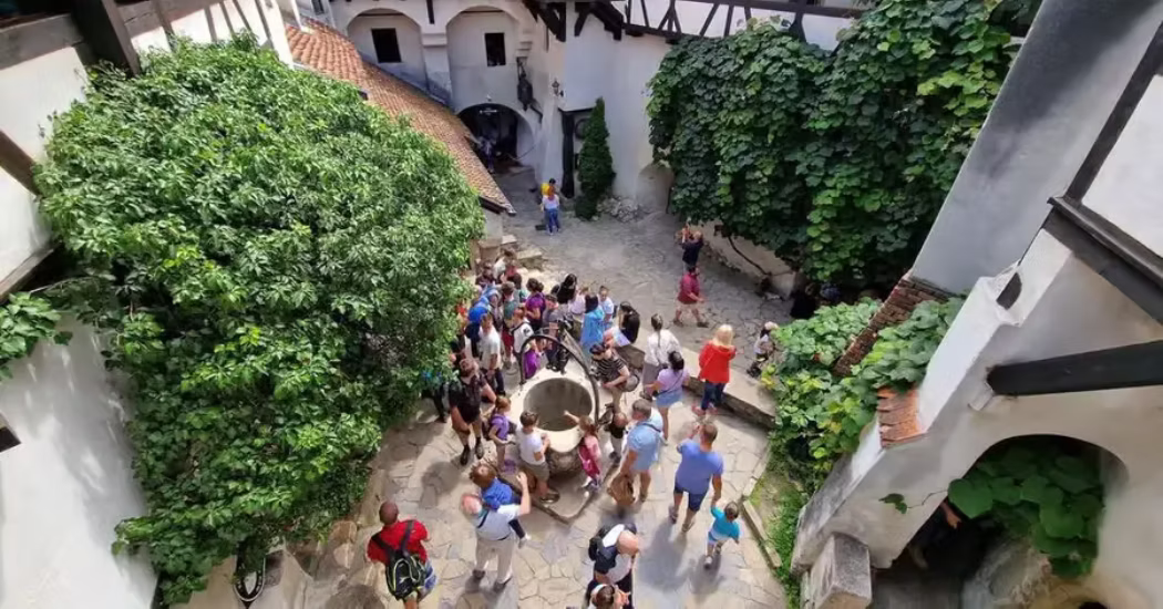 Tourists exploring Bran Castle in Romania. 